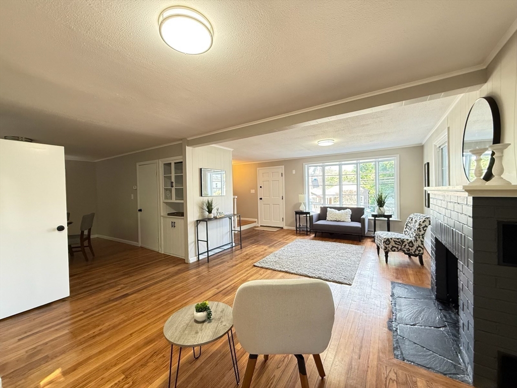 37 Bridge Street Monson, MA 01057 - Photo 6 of 35 a living room with furniture and a fireplace