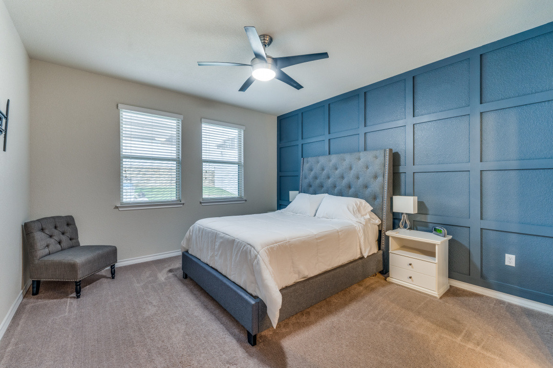 5921 Lehman Way Austin, TX 78747 - Photo 12 of 25 A tranquil bedroom features warm carpeting and dual windows, with a striking accent wall.