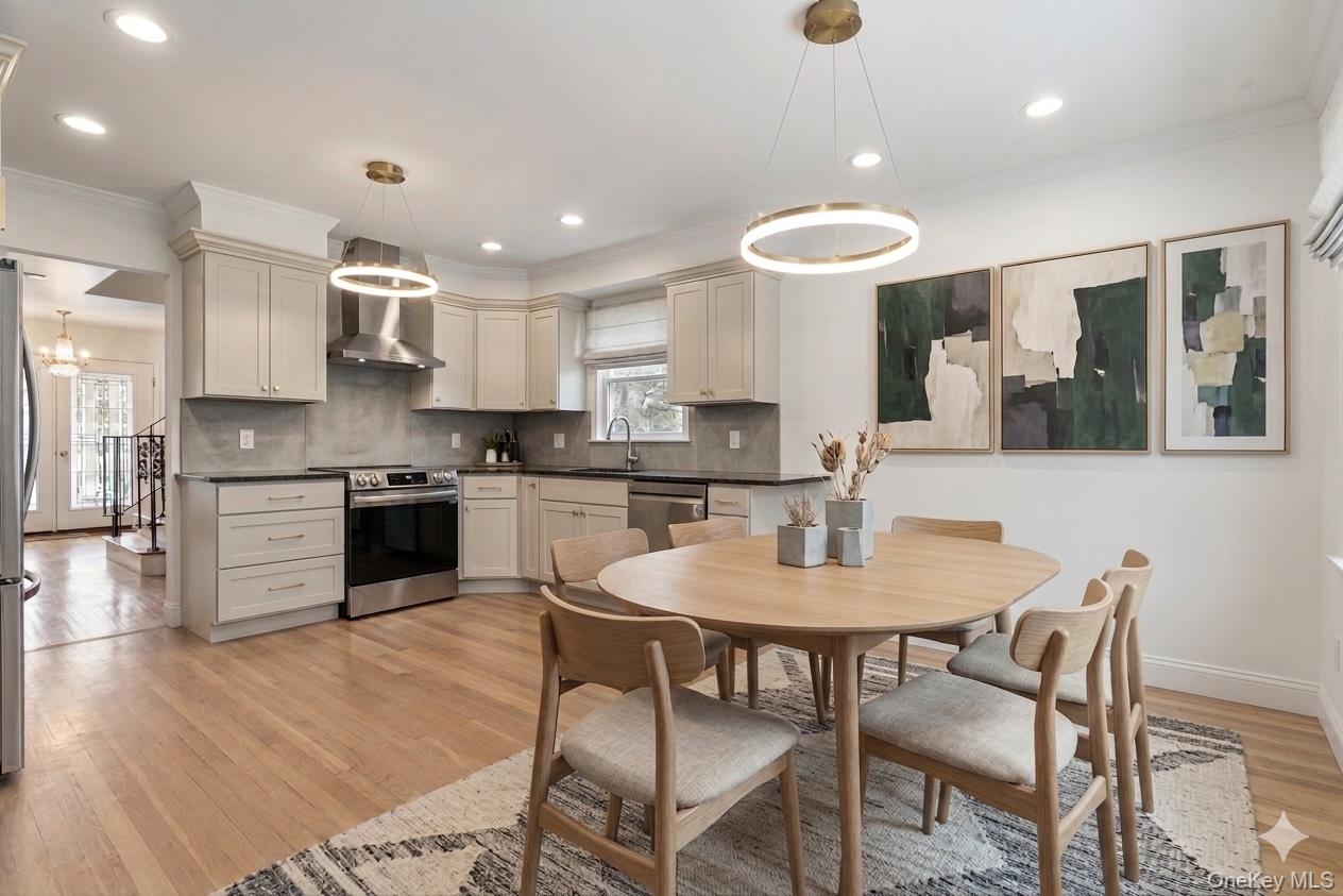20 Old Farm Road Scarsdale, NY 10583 - Photo 8 of 27 a kitchen with stainless steel appliances granite countertop a stove top oven a sink dishwasher a dining table and chairs with wooden floor