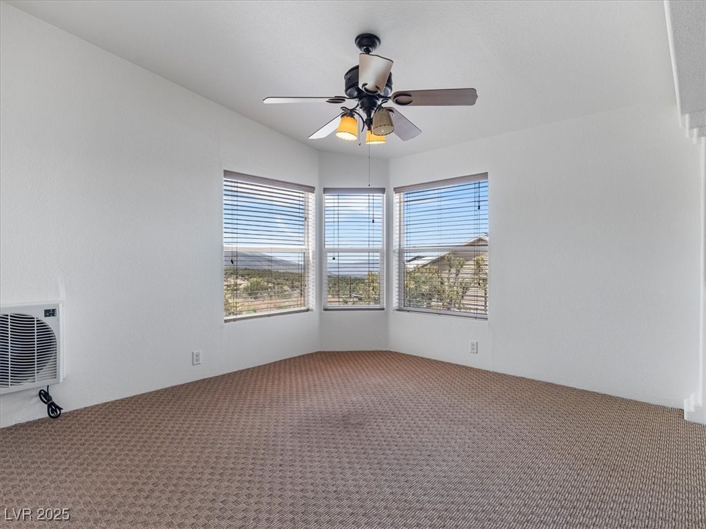 70 West Bonanza Road Las Vegas, NV 89124 - Photo 22 of 71 Empty room featuring carpet flooring, ceiling fan, and heating unit