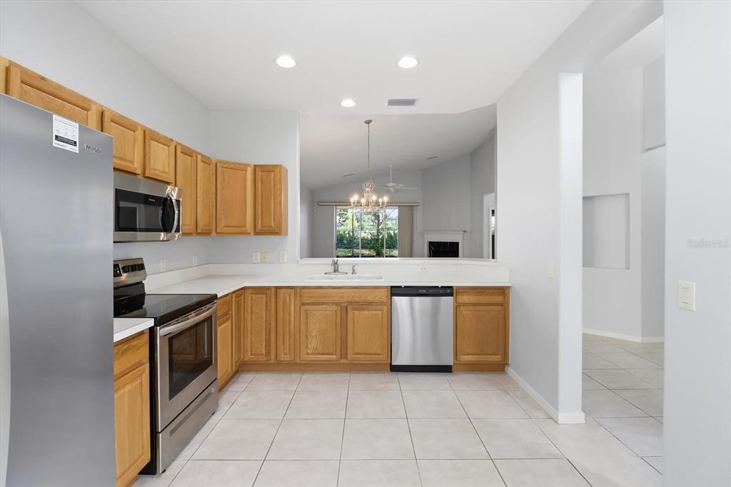 1196 West Diamond Shore Loop Hernando, FL 34442 - Photo 12 of 40 a kitchen with stainless steel appliances granite countertop a sink and cabinets