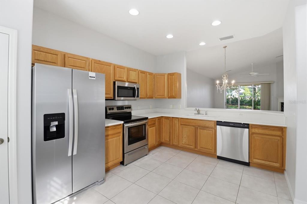 1196 West Diamond Shore Loop Hernando, FL 34442 - Photo 13 of 40 a large kitchen with stainless steel appliances granite countertop a refrigerator and a sink
