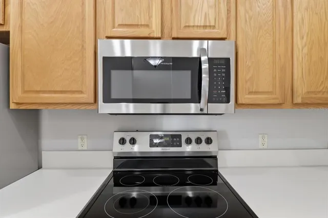 a kitchen with a stove and a microwave
