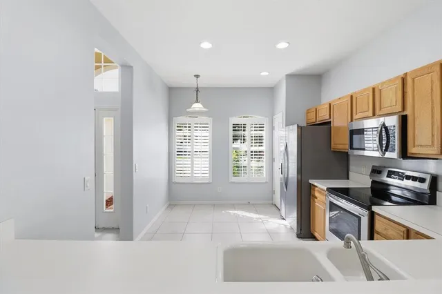 a kitchen with stainless steel appliances granite countertop a refrigerator and a sink