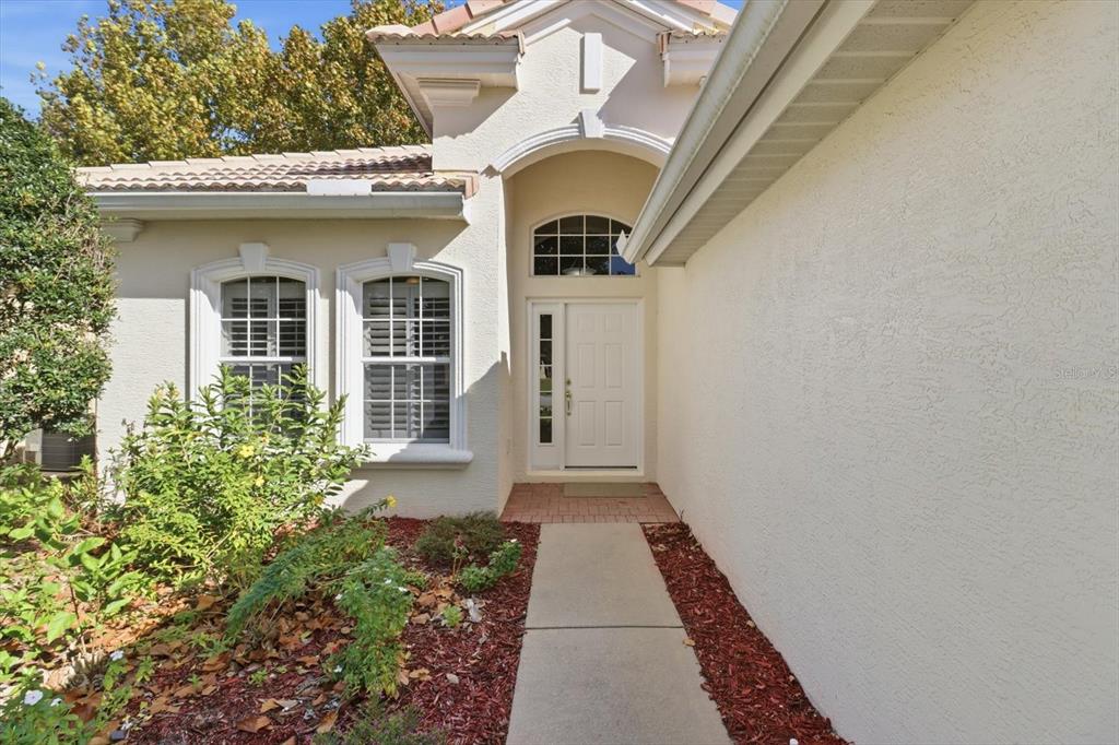 1196 West Diamond Shore Loop Hernando, FL 34442 - Photo 4 of 40 a front view of a house with garden