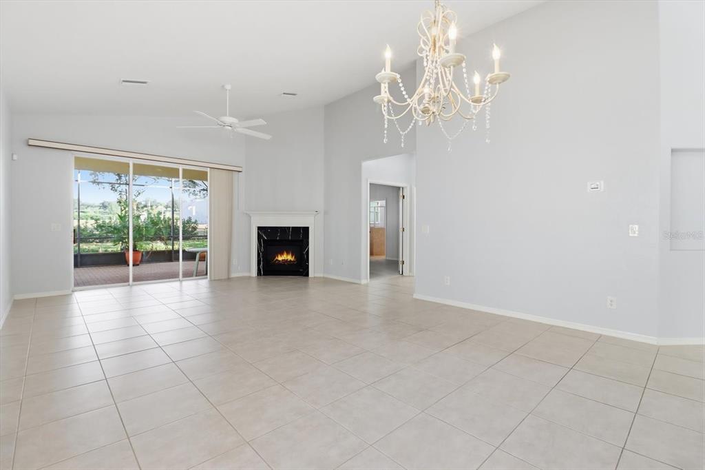 1196 West Diamond Shore Loop Hernando, FL 34442 - Photo 7 of 40 a view of a livingroom with a chandelier fan and windows