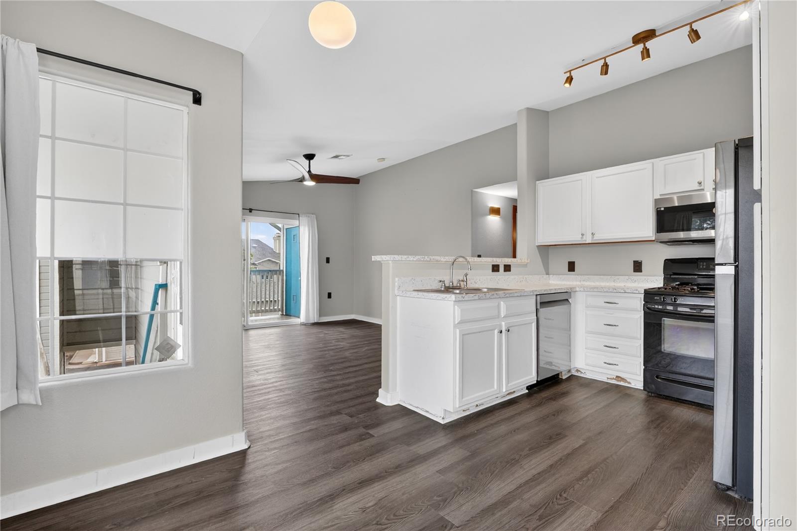 8406 Pebble Creek Way, Unit 204 Highlands Ranch, CO 80126 - Photo 13 of 29 a kitchen with a sink cabinets and wooden floor