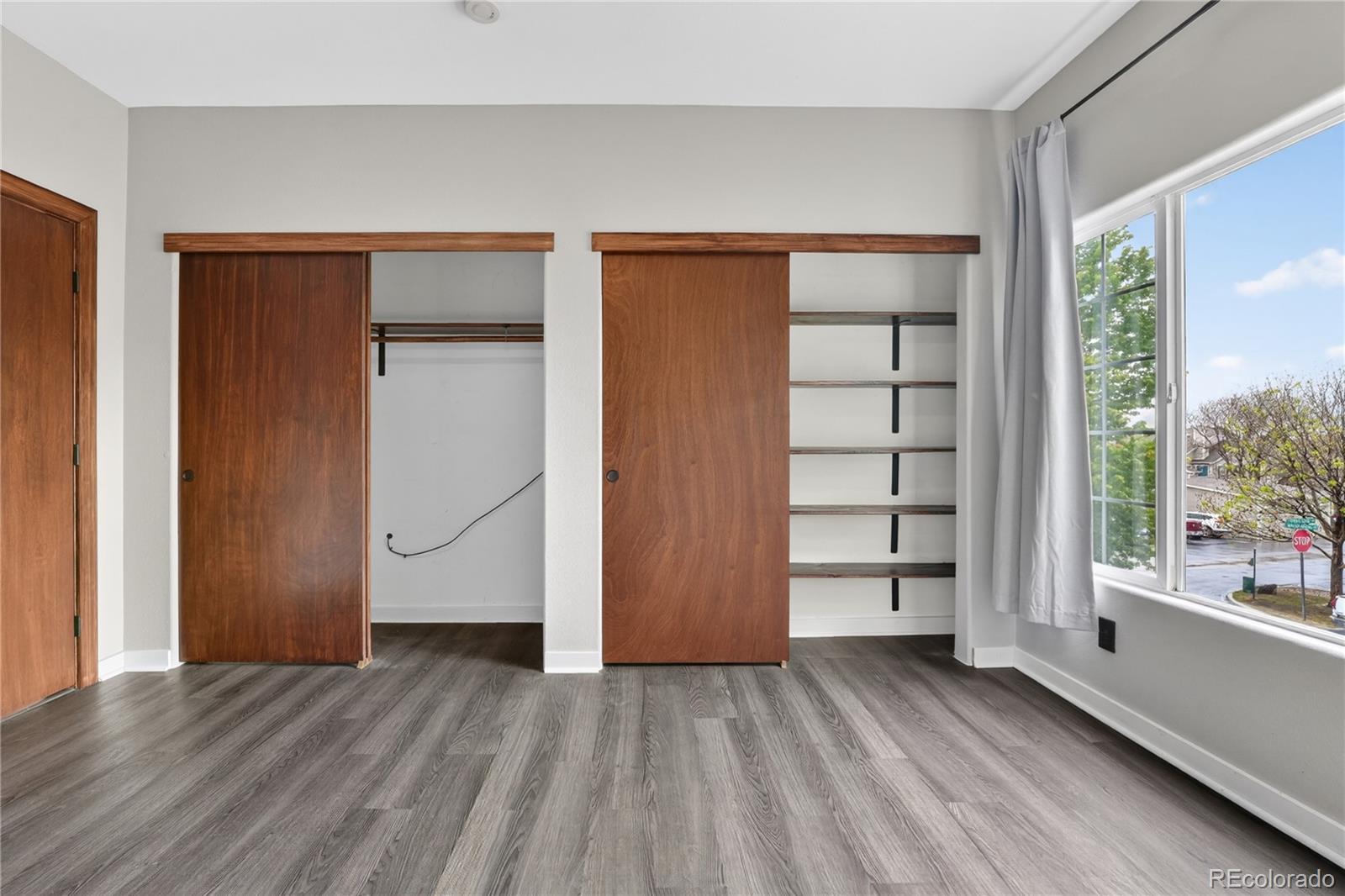 8406 Pebble Creek Way, Unit 204 Highlands Ranch, CO 80126 - Photo 20 of 29 an empty room with closet and wooden floor
