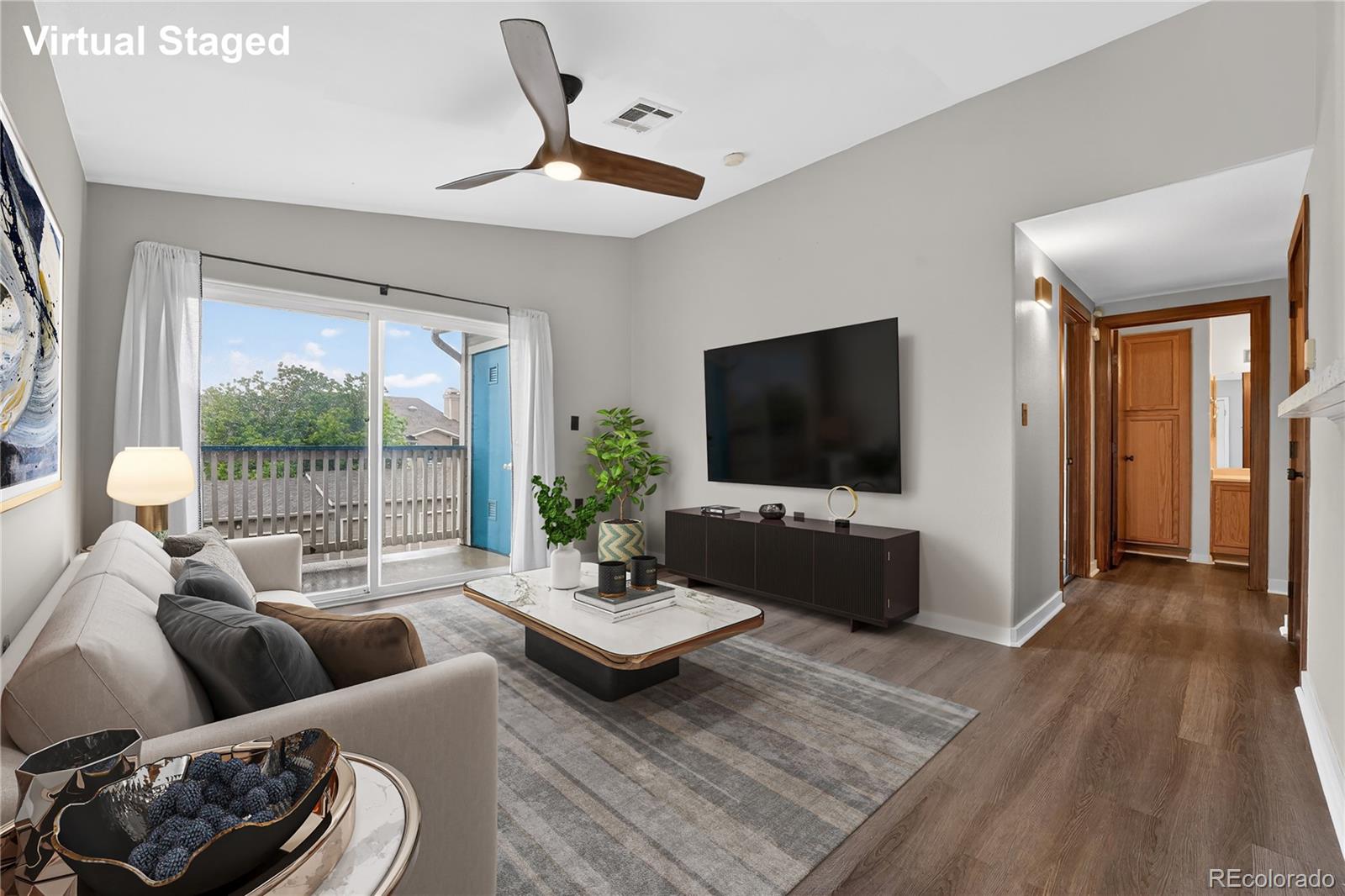 8406 Pebble Creek Way, Unit 204 Highlands Ranch, CO 80126 - Photo 2 of 29 a living room with furniture and a flat screen tv