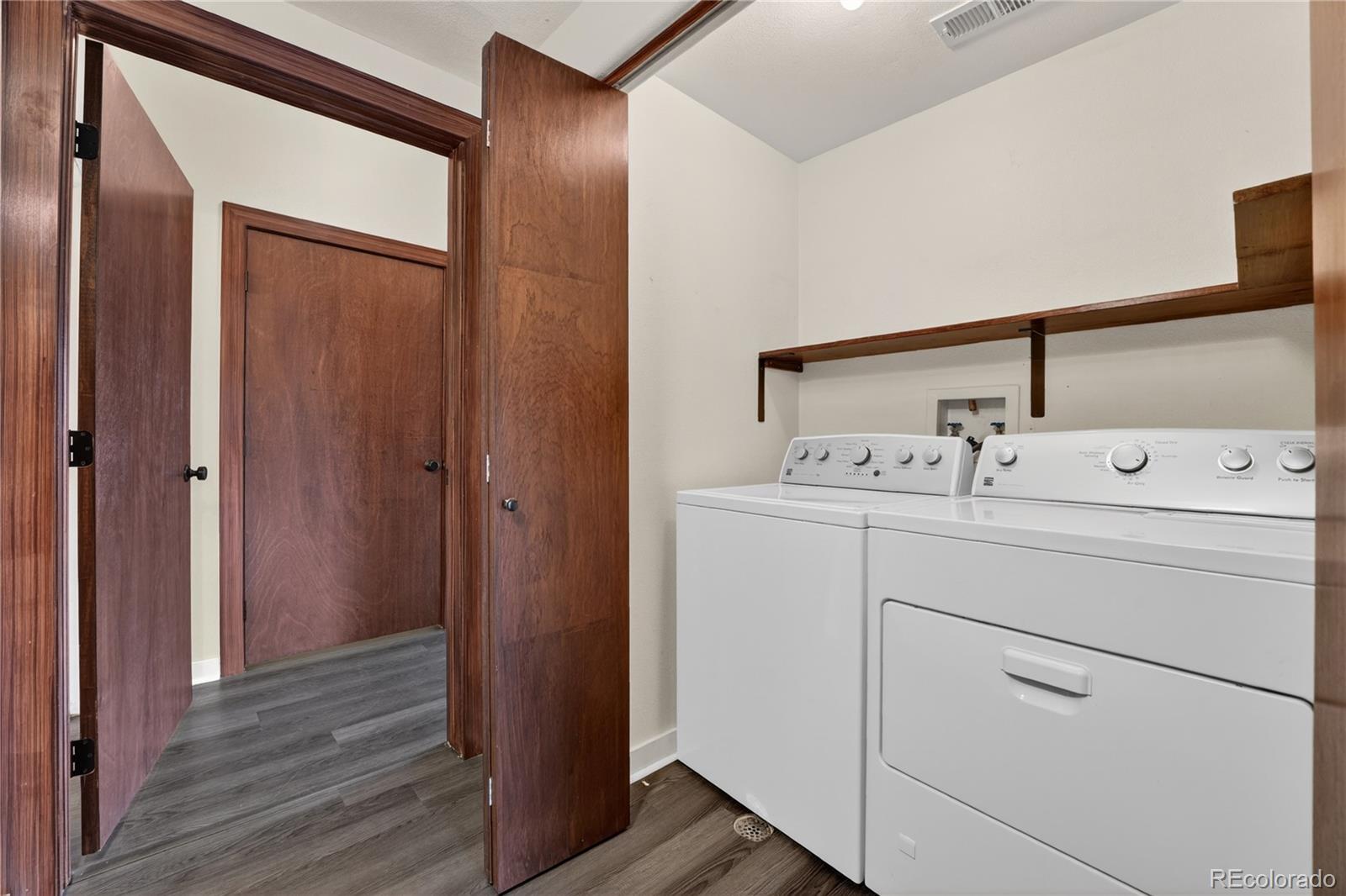 8406 Pebble Creek Way, Unit 204 Highlands Ranch, CO 80126 - Photo 22 of 29 a utility room with cabinets washer and dryer