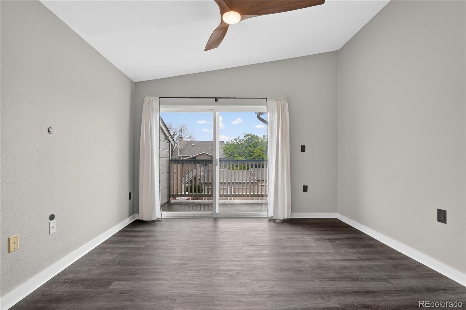 8406 Pebble Creek Way, Unit 204 Highlands Ranch, CO 80126 - Photo 7 of 29 wooden floor in an empty room with a window