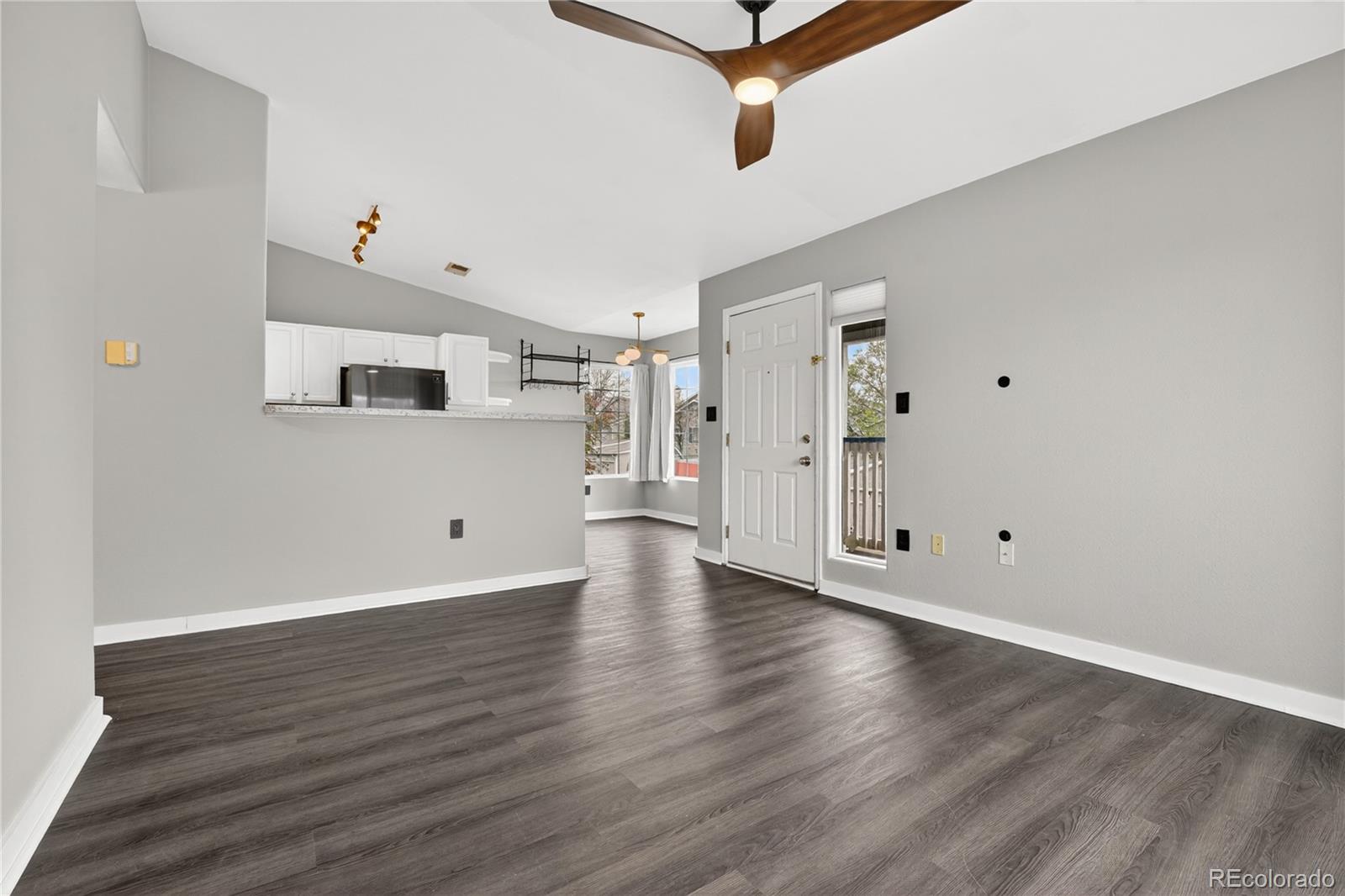 8406 Pebble Creek Way, Unit 204 Highlands Ranch, CO 80126 - Photo 9 of 29 a view of an empty room with wooden floor