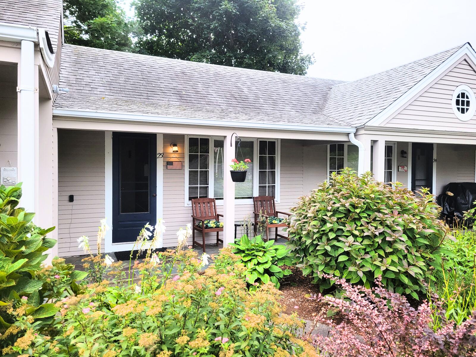 405 Lower County Road, Unit 23 Harwich Port, MA 02646 - Photo 11 of 24 a front view of a house with garden