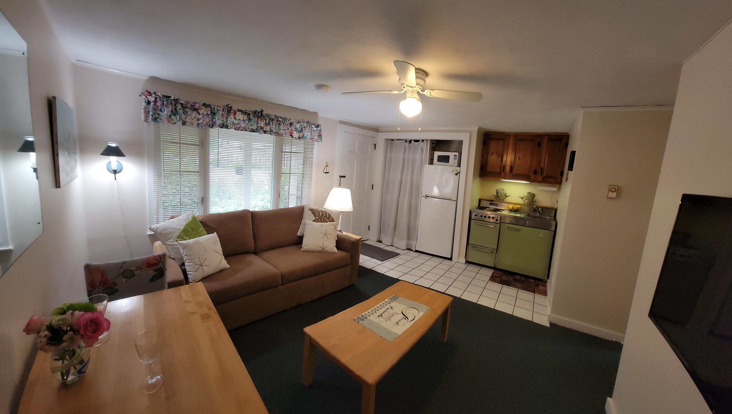 405 Lower County Road, Unit 23 Harwich Port, MA 02646 - Photo 14 of 24 a living room with furniture and a flat screen tv