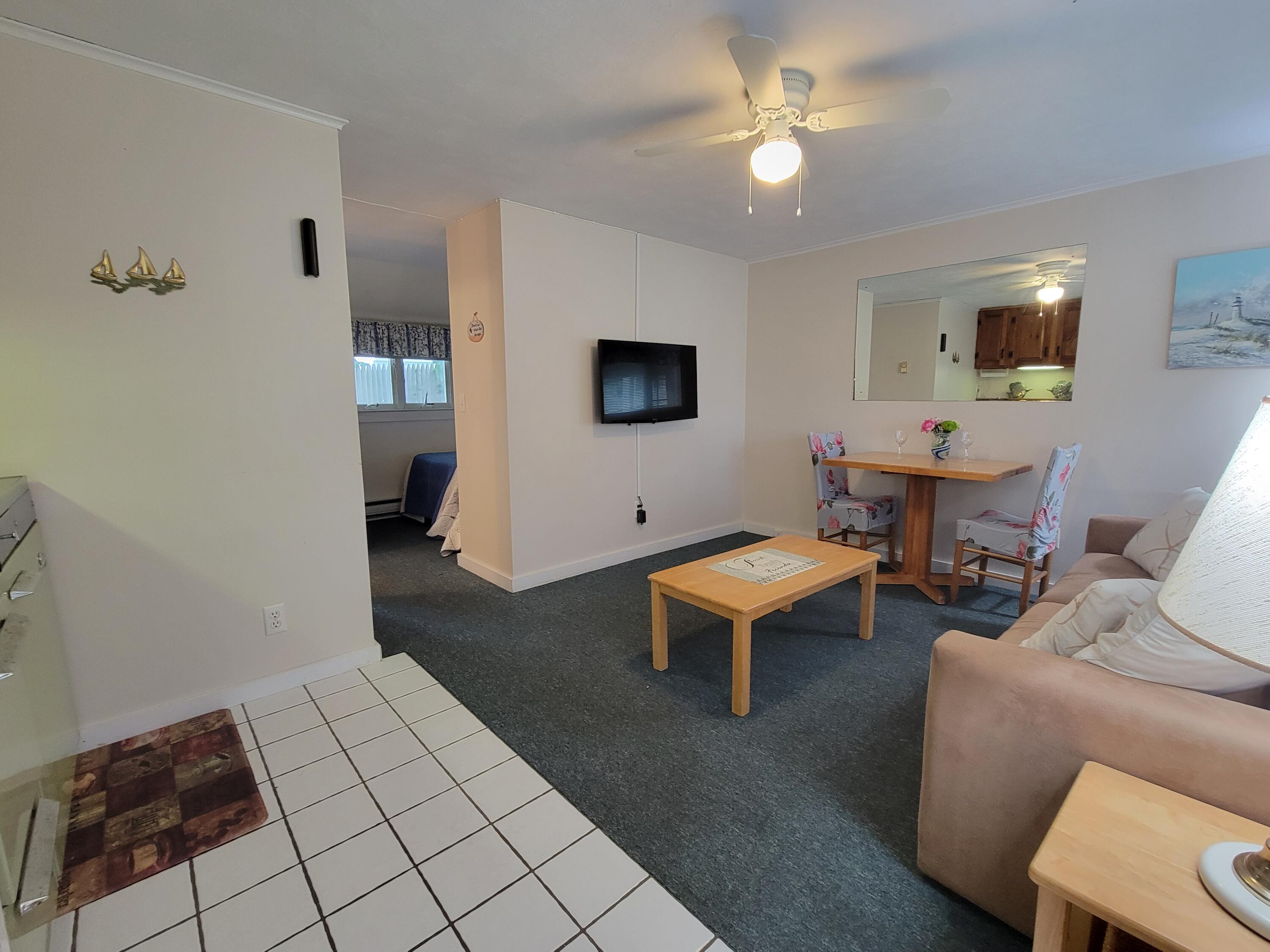 405 Lower County Road, Unit 23 Harwich Port, MA 02646 - Photo 15 of 24 a living room with furniture and a flat screen tv