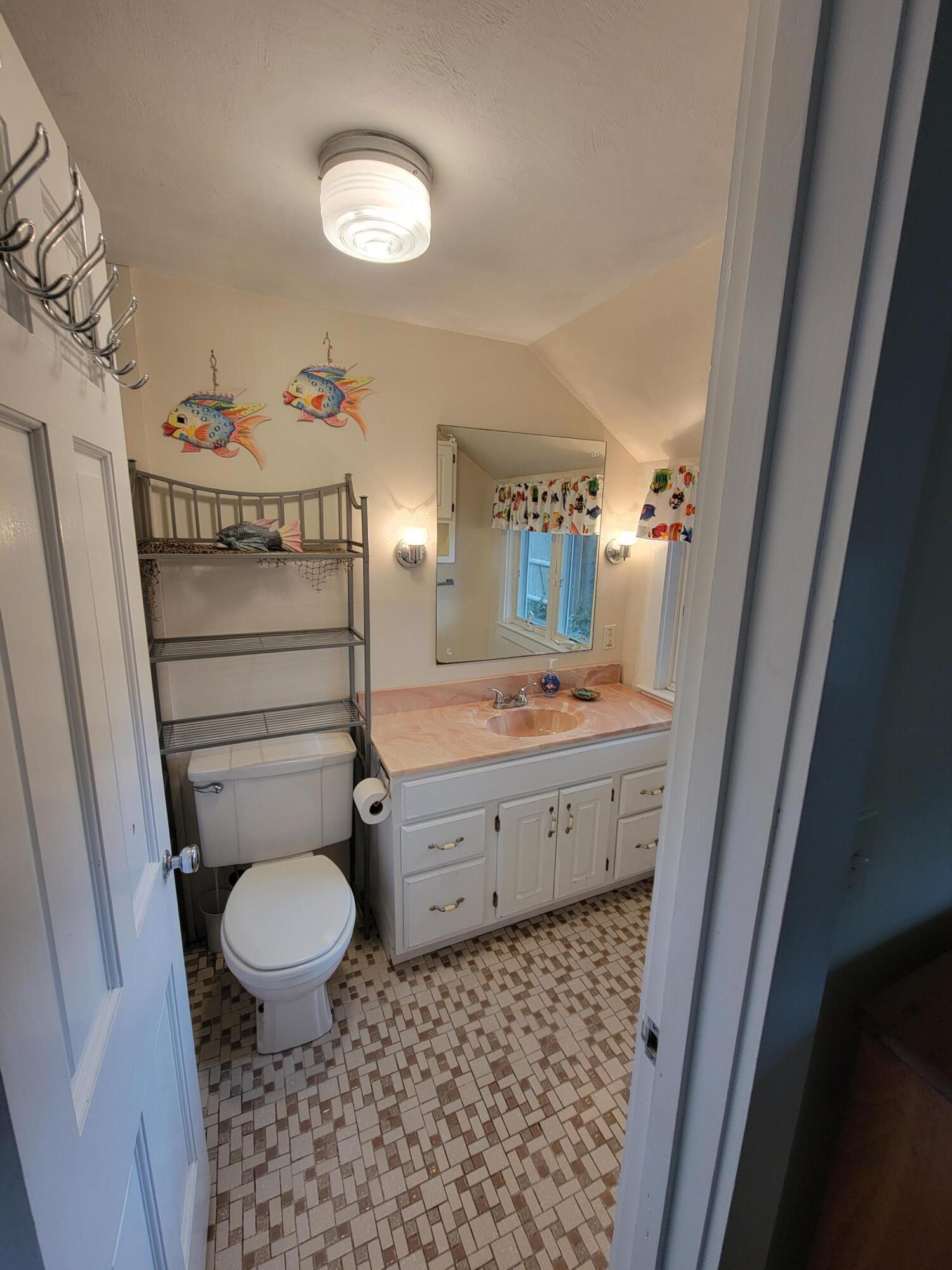 405 Lower County Road, Unit 23 Harwich Port, MA 02646 - Photo 18 of 24 a bathroom with a granite countertop toilet a sink and a mirror