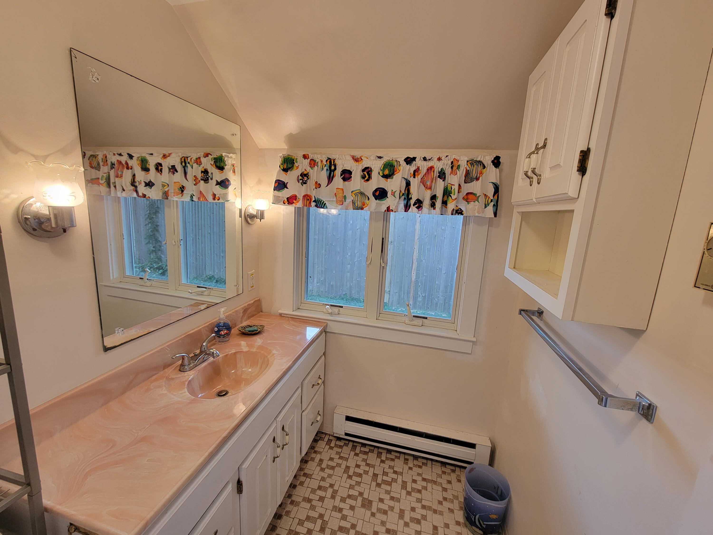 405 Lower County Road, Unit 23 Harwich Port, MA 02646 - Photo 20 of 24 a bathroom with a sink a mirror and a shower