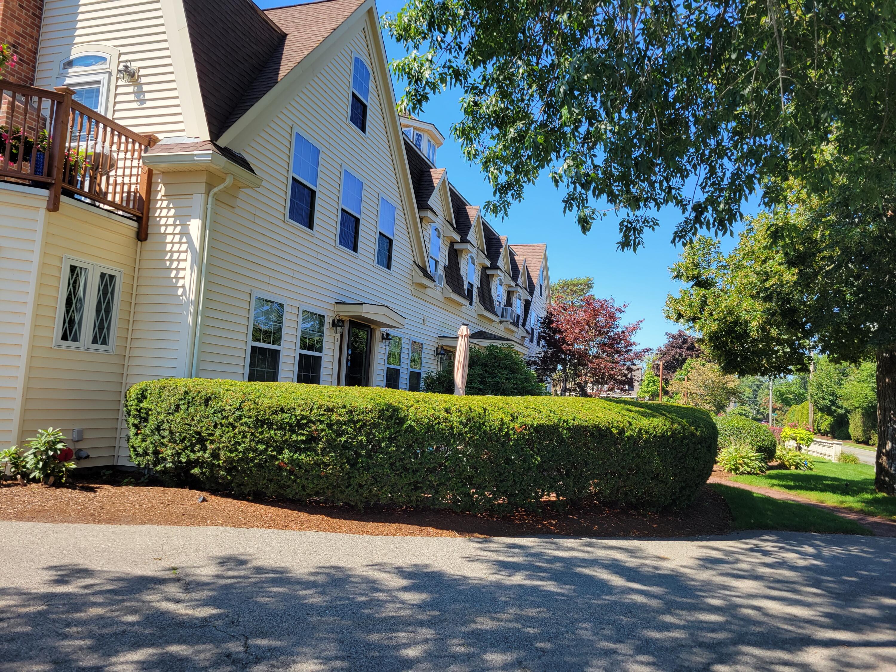 405 Lower County Road, Unit 23 Harwich Port, MA 02646 - Photo 2 of 24 a front view of a house with a yard