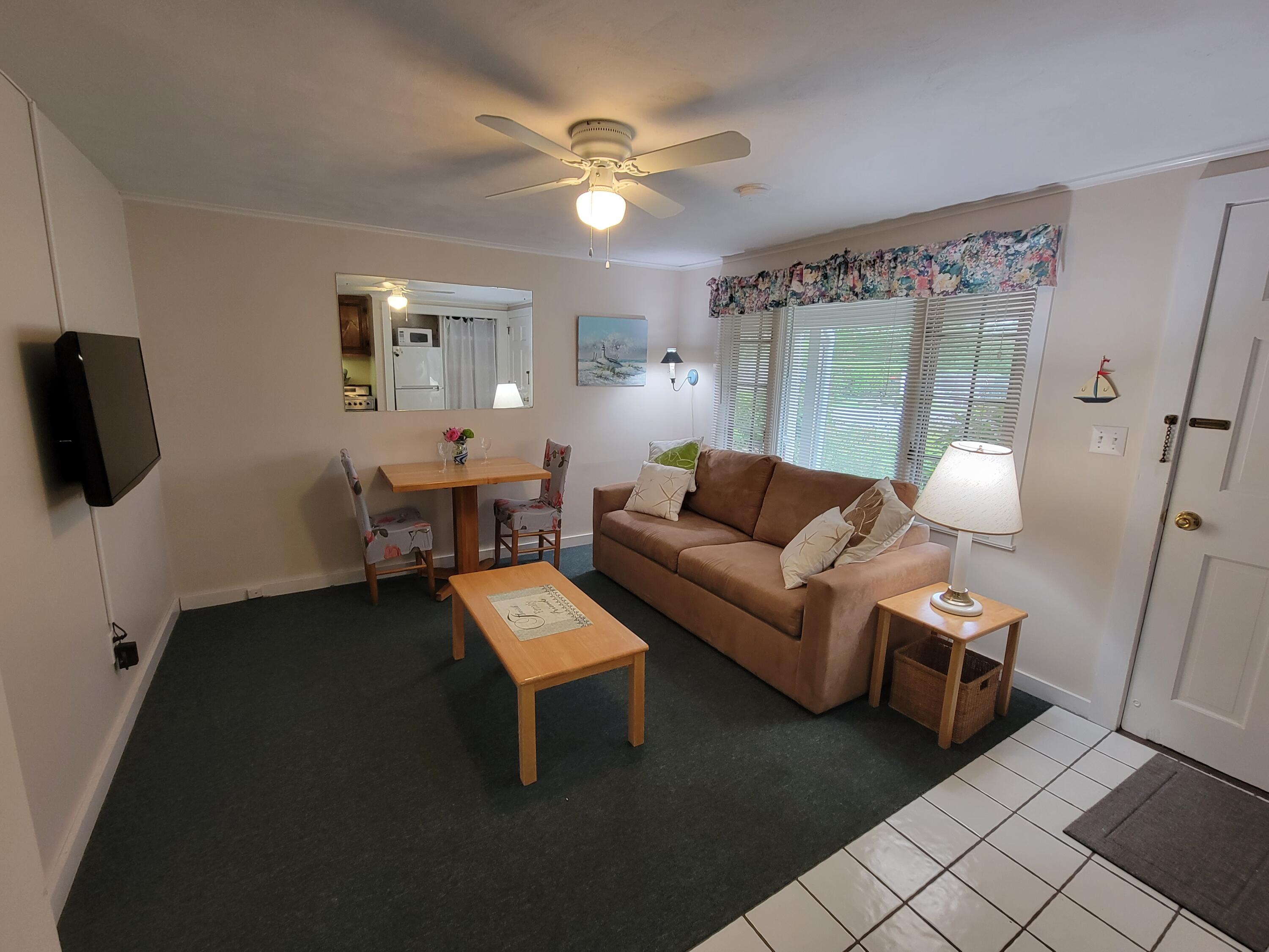 405 Lower County Road, Unit 23 Harwich Port, MA 02646 - Photo 21 of 24 a living room with furniture and a window