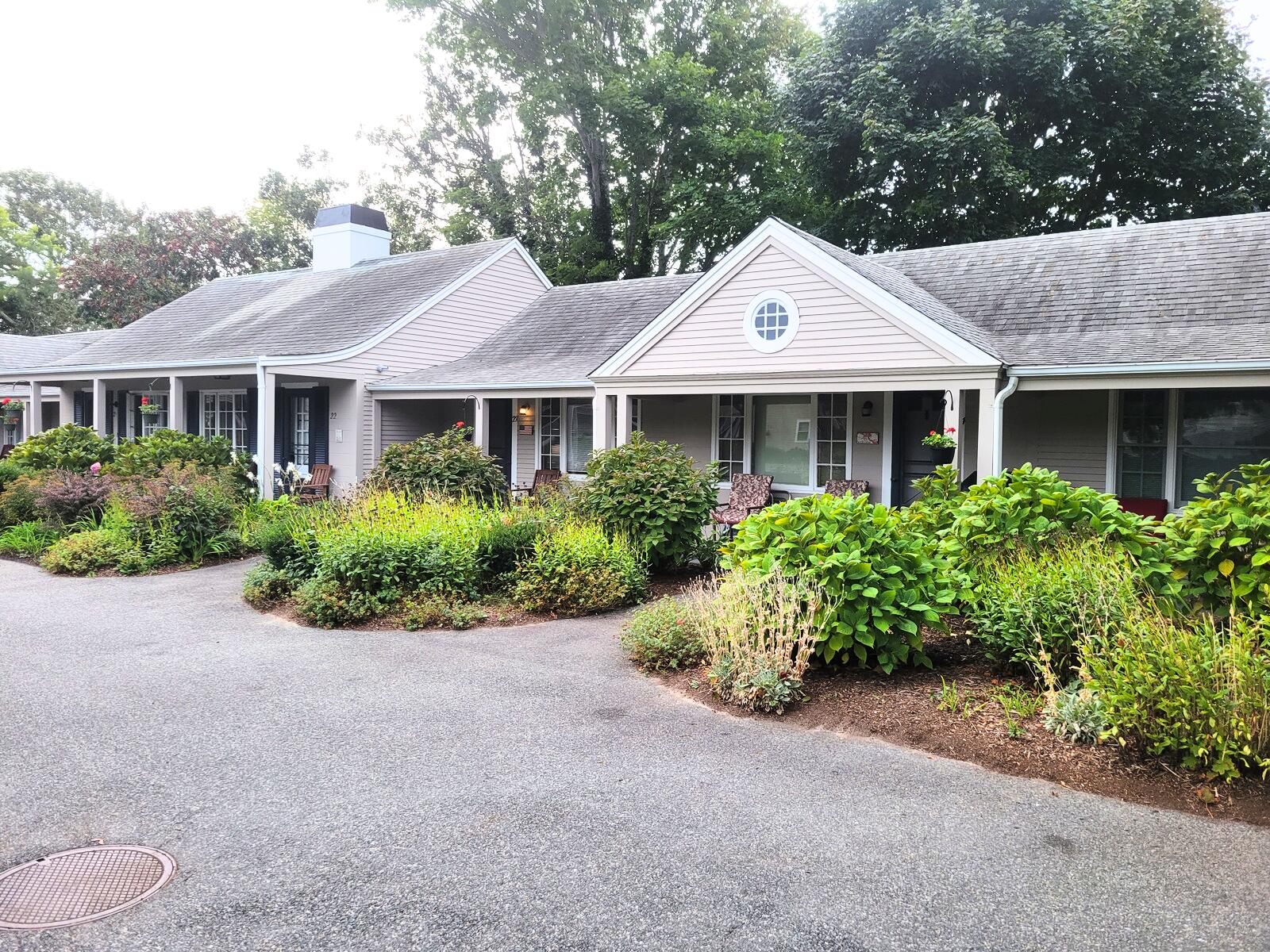 405 Lower County Road, Unit 23 Harwich Port, MA 02646 - Photo 23 of 24 a front view of a house with a yard and garage