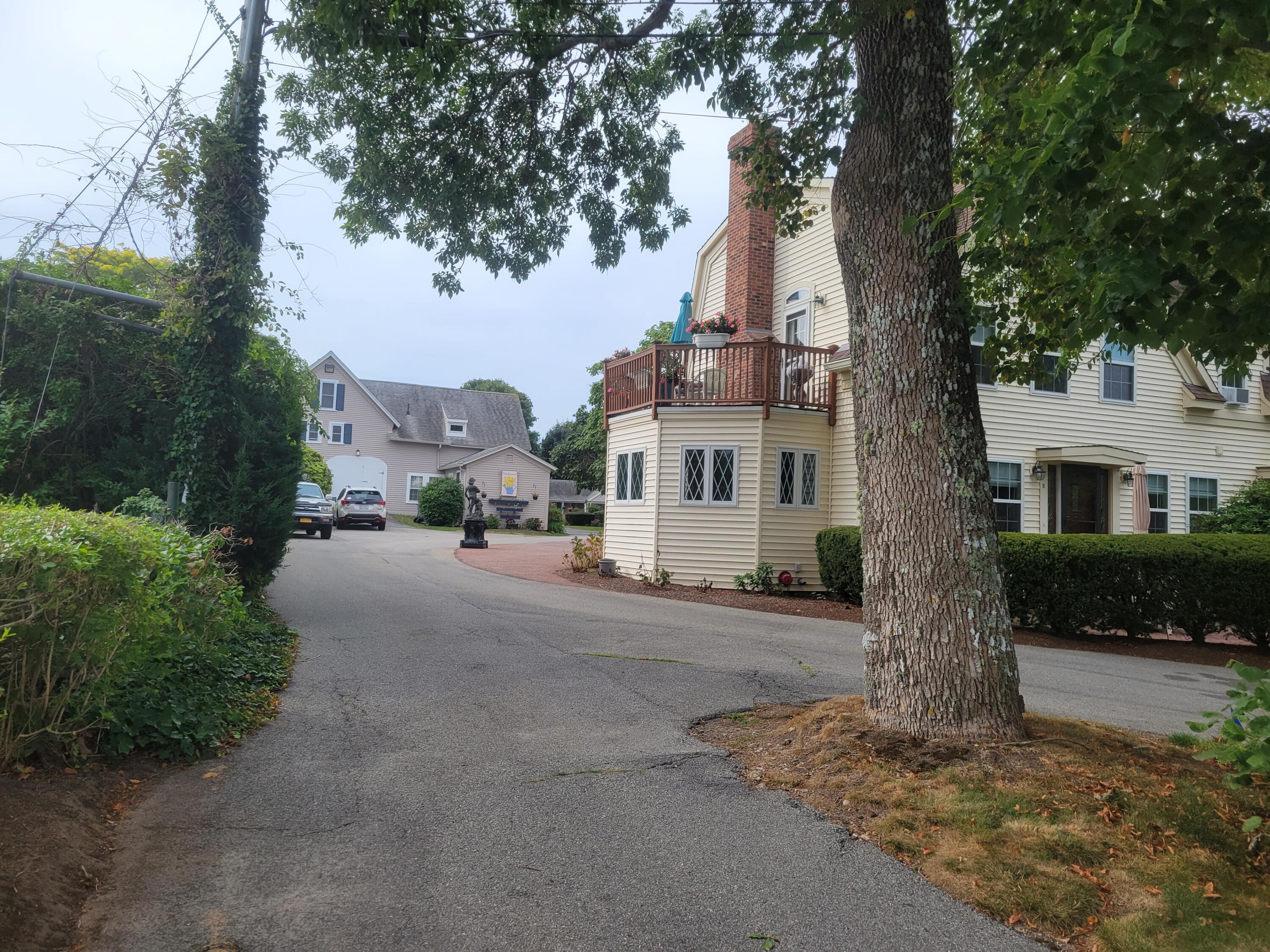 405 Lower County Road, Unit 23 Harwich Port, MA 02646 - Photo 3 of 24 a front view of a house with a yard and garage