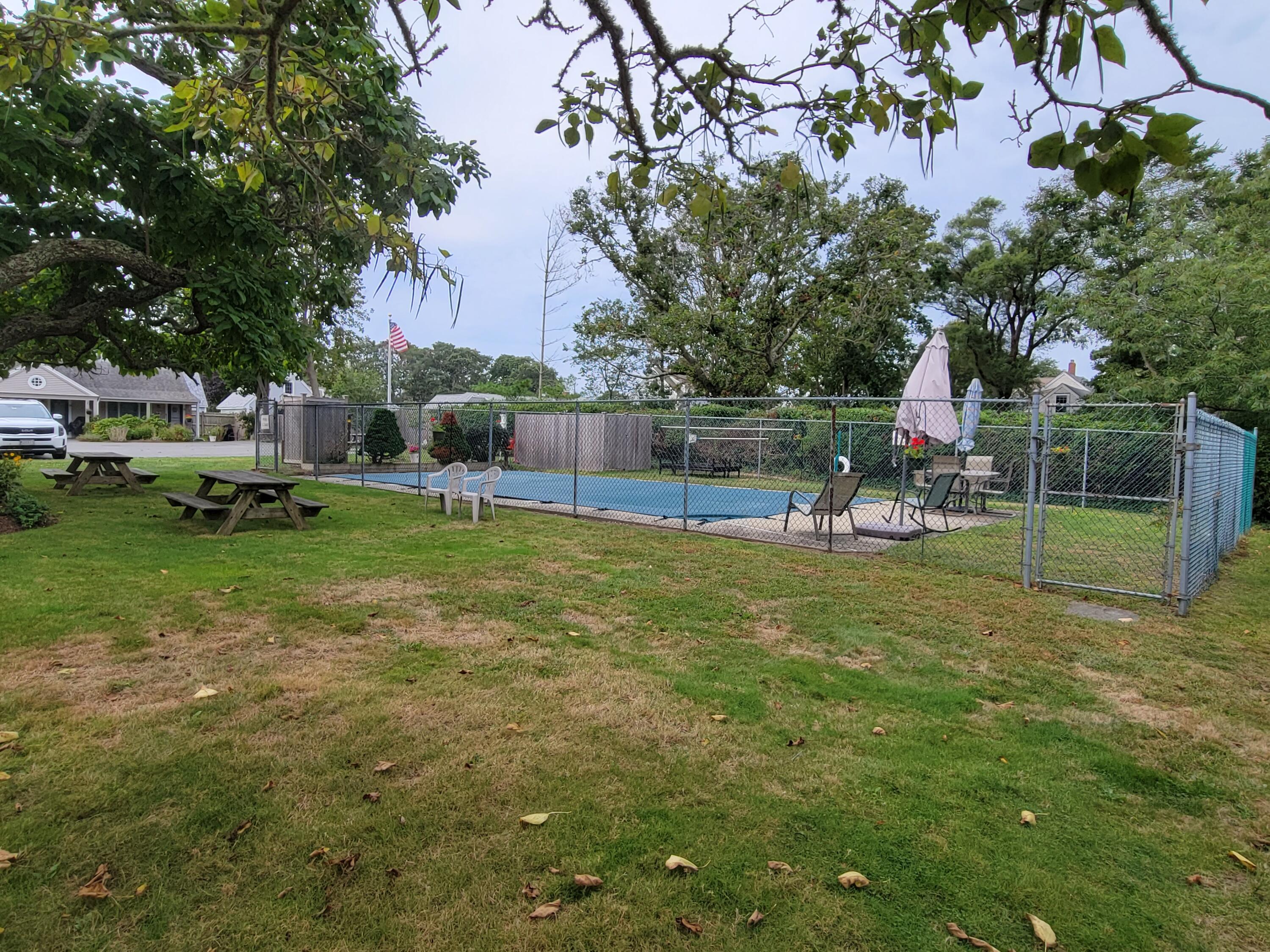 405 Lower County Road, Unit 23 Harwich Port, MA 02646 - Photo 6 of 24 a view of a house with a yard