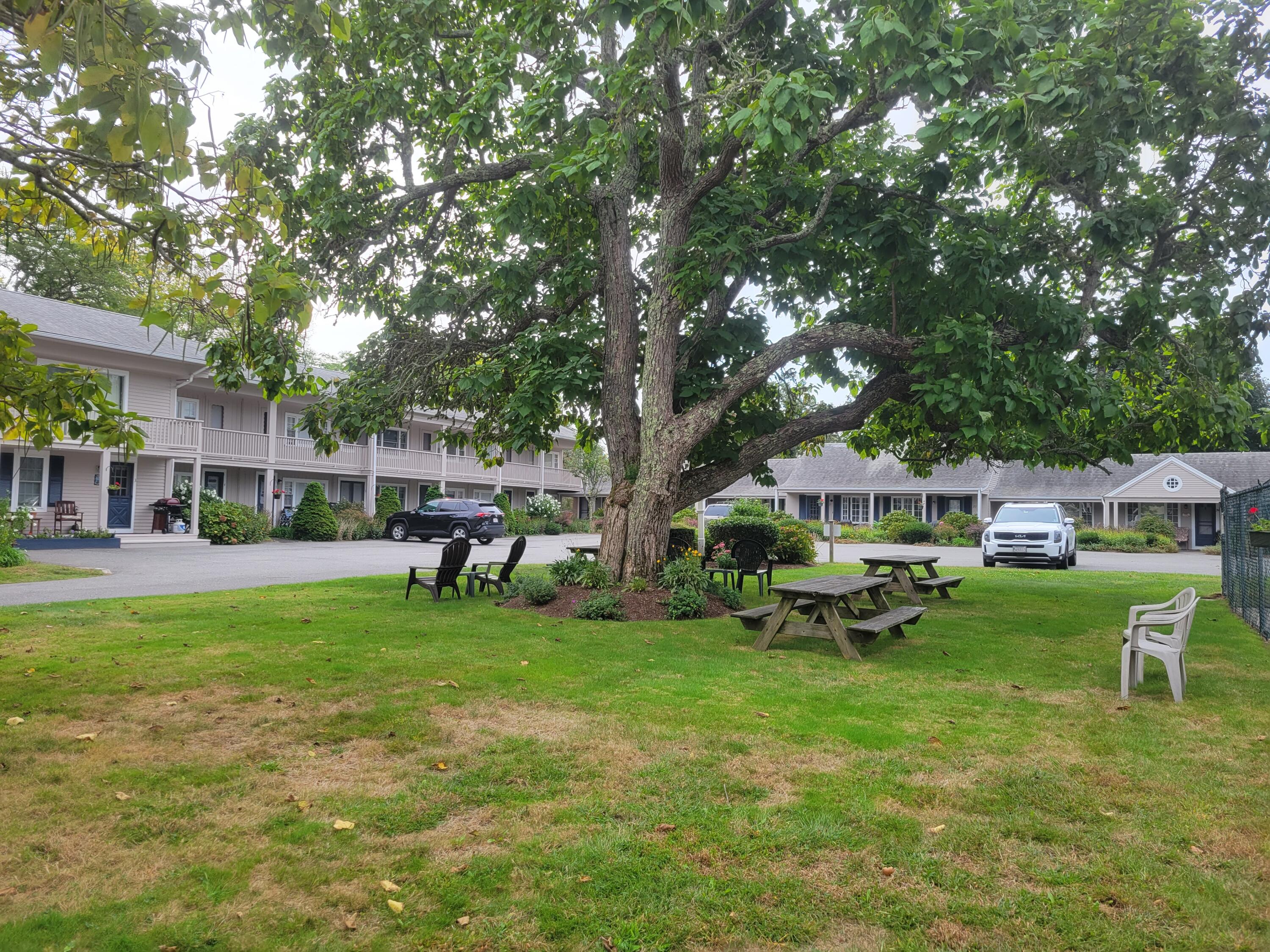 405 Lower County Road, Unit 23 Harwich Port, MA 02646 - Photo 8 of 24 a view of a house with backyard sitting area and garden