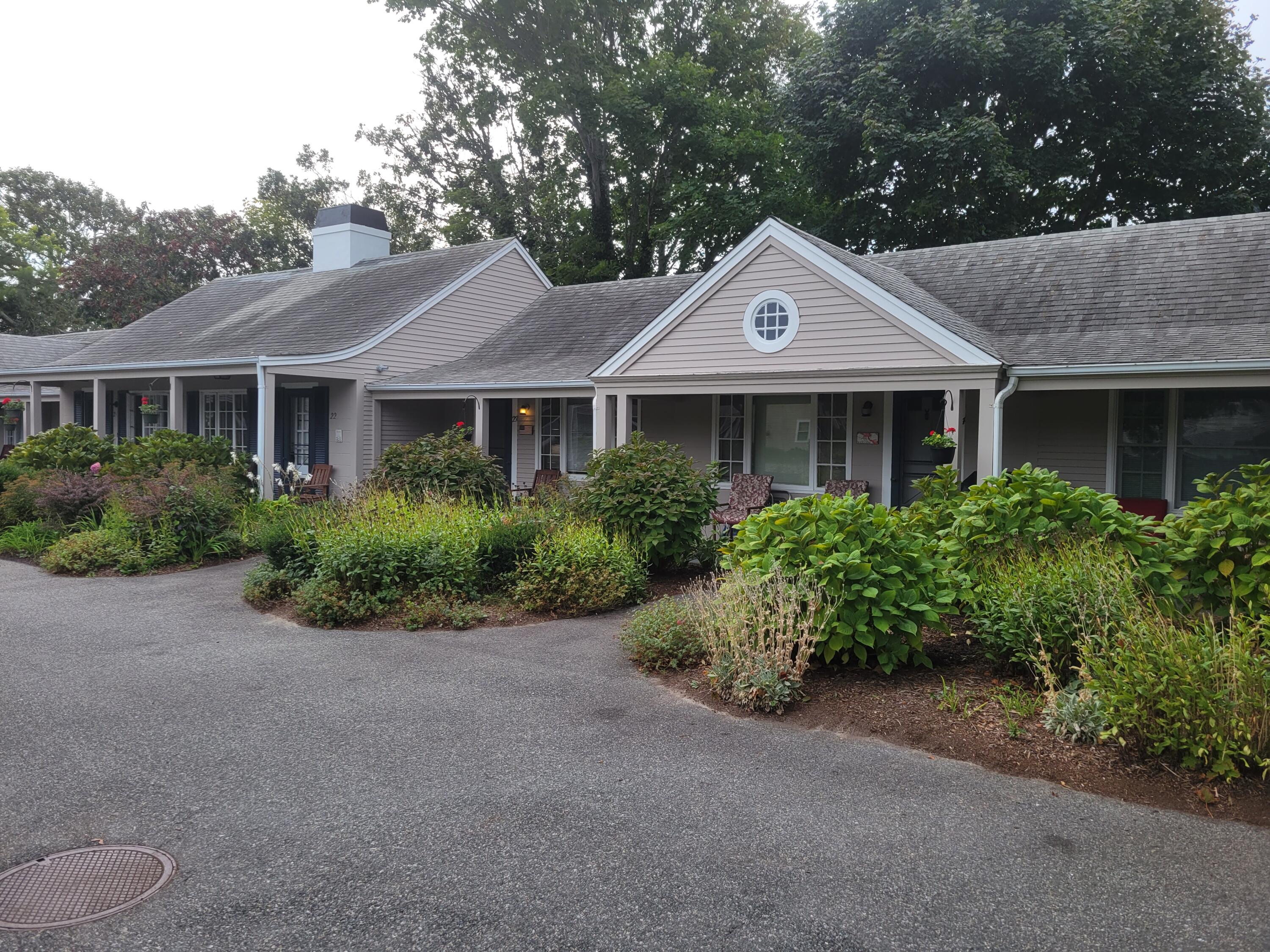 405 Lower County Road, Unit 23 Harwich Port, MA 02646 - Photo 10 of 24 a front view of a house with a yard