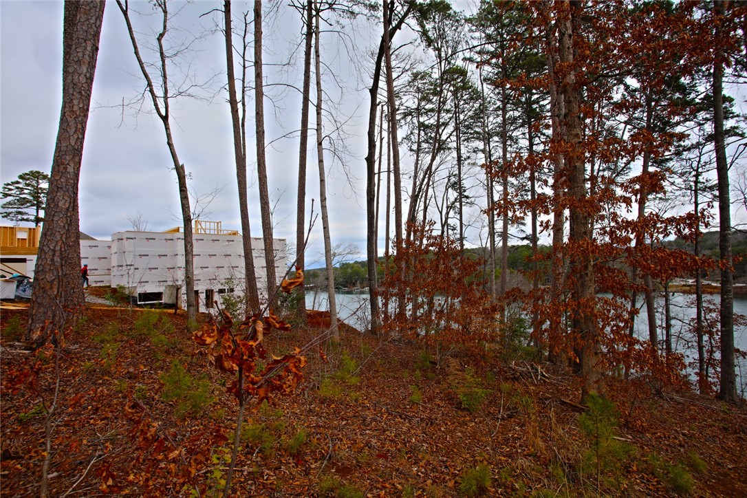 Lot 131 Harbor Point Seneca, SC 29672 - Photo 37 of 48 This building site offers serene forest views alongside a tranquil body of water.