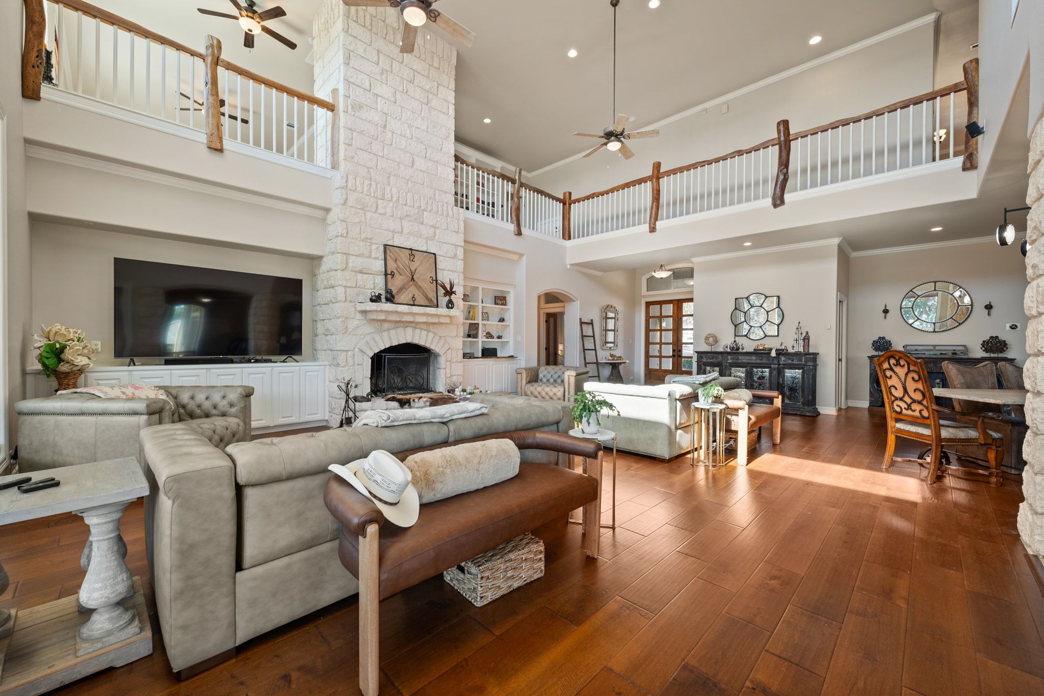 185 Shimmering Shore Court Spring Branch, TX 78070 - Photo 8 of 36 Living area with a fireplace, hardwood / wood-style flooring, ceiling fan, recessed lighting, and a high ceiling