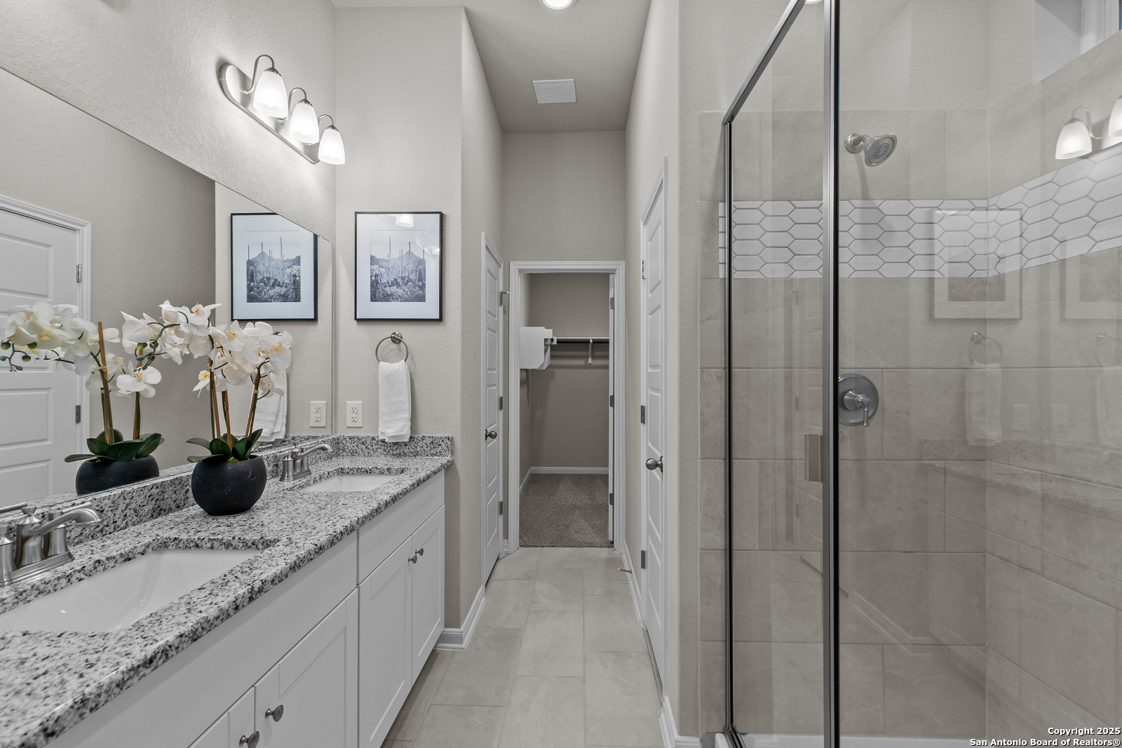 15593 Bonnethead Road San Antonio, TX 78253 - Photo 6 of 11 a bathroom with a granite countertop sink a mirror and shower