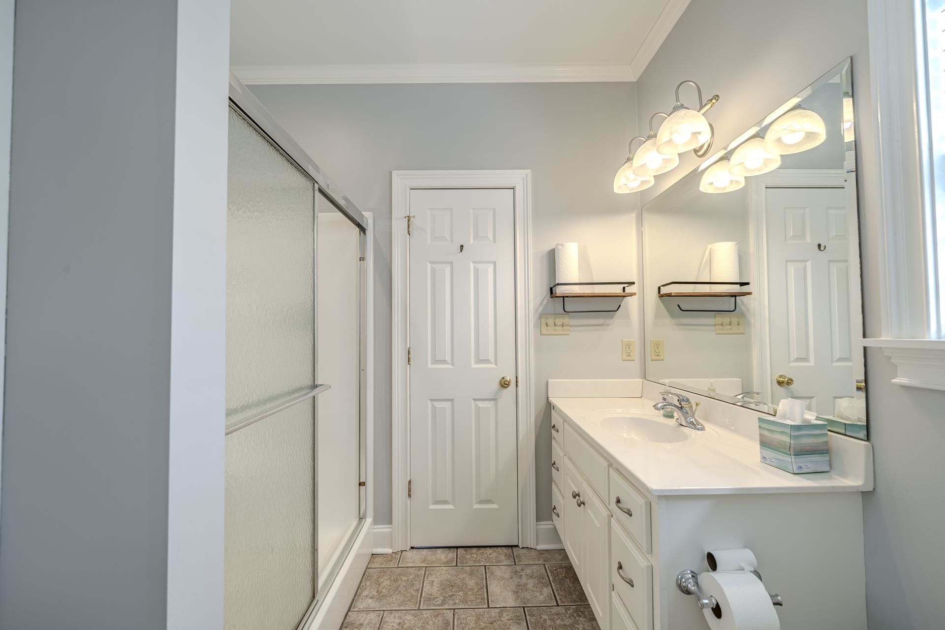 9 Mountain View Iuka, MS 38852 - Photo 18 of 32 Bathroom featuring vanity, a stall shower, ornamental molding, and light tile patterned floors