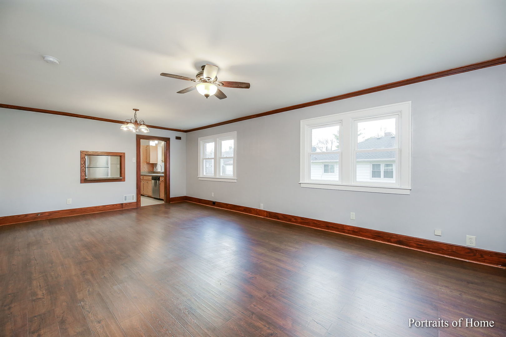 952 Black Road Joliet, IL 60435 - Photo 5 of 25 a view of an empty room with wooden floor and a window