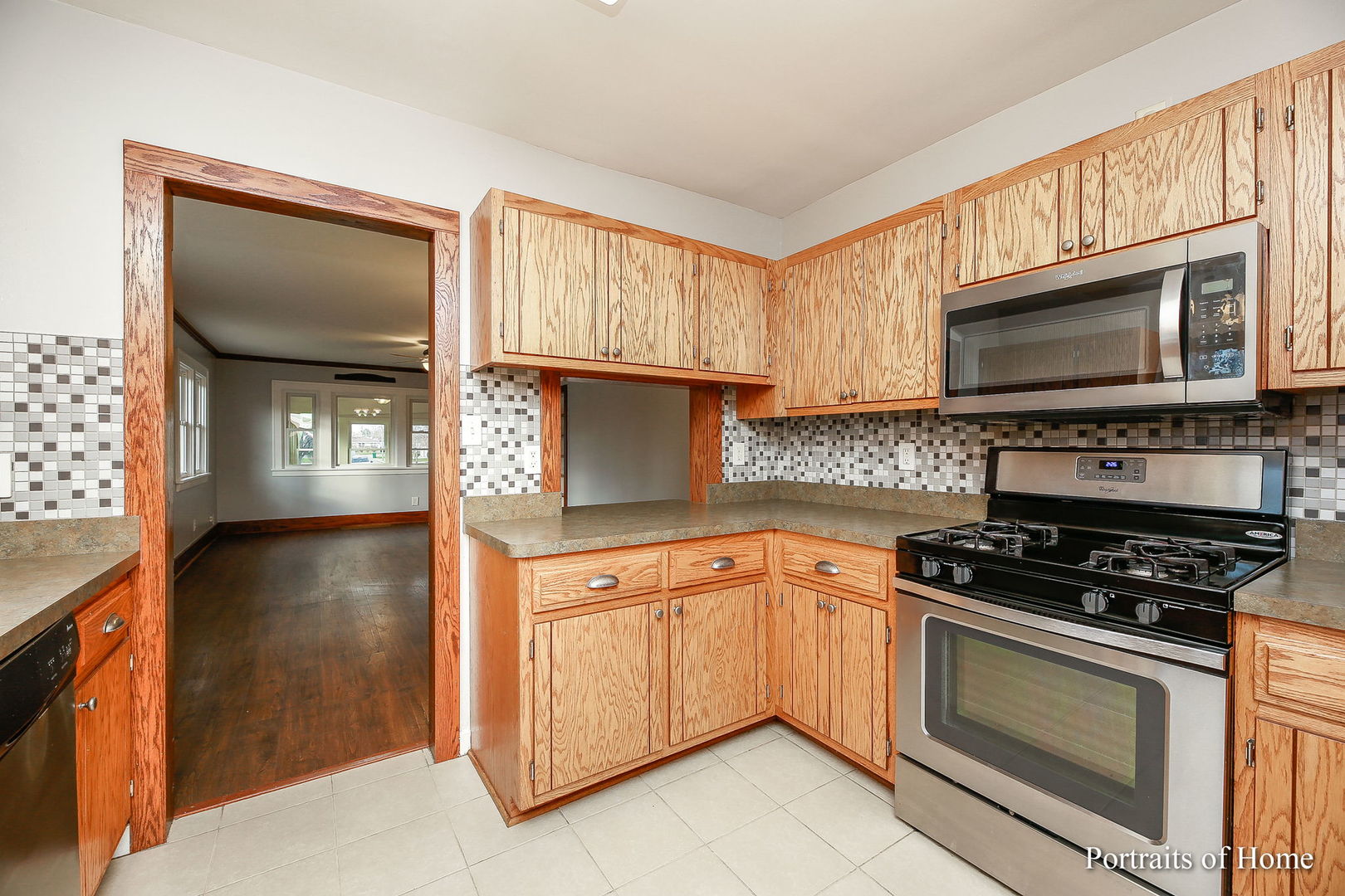 952 Black Road Joliet, IL 60435 - Photo 8 of 25 a kitchen with granite countertop a stove top oven microwave and cabinets
