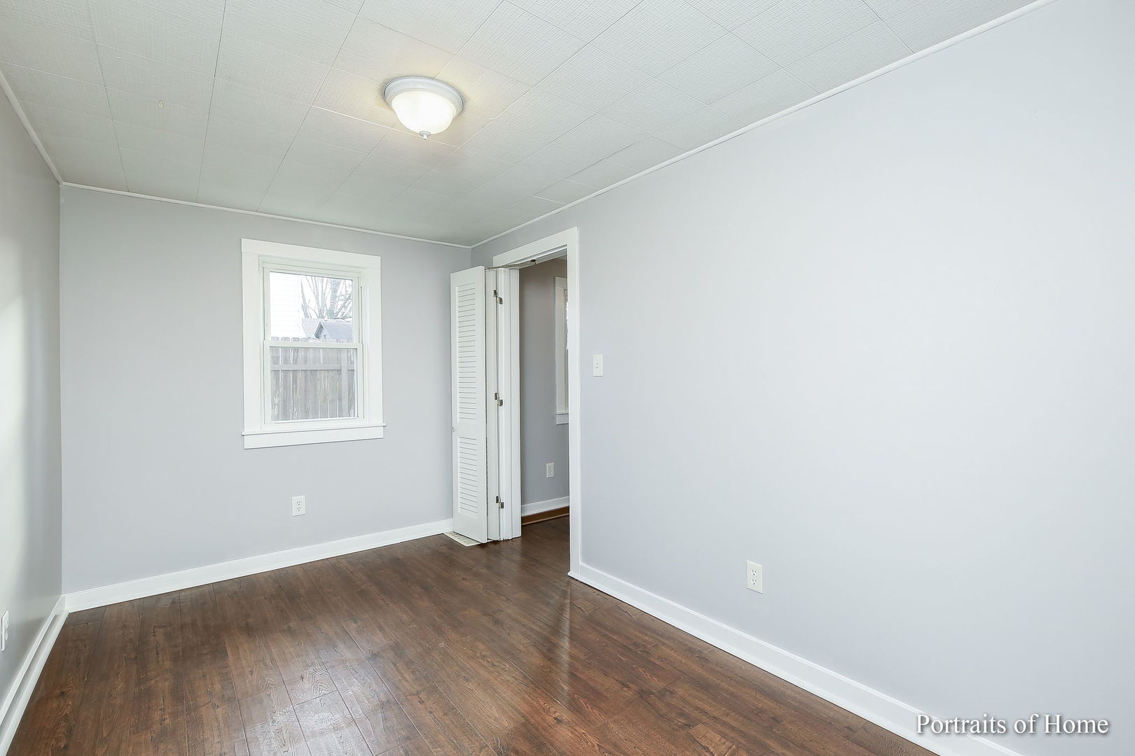 952 Black Road Joliet, IL 60435 - Photo 9 of 25 an empty room with wooden floor and windows