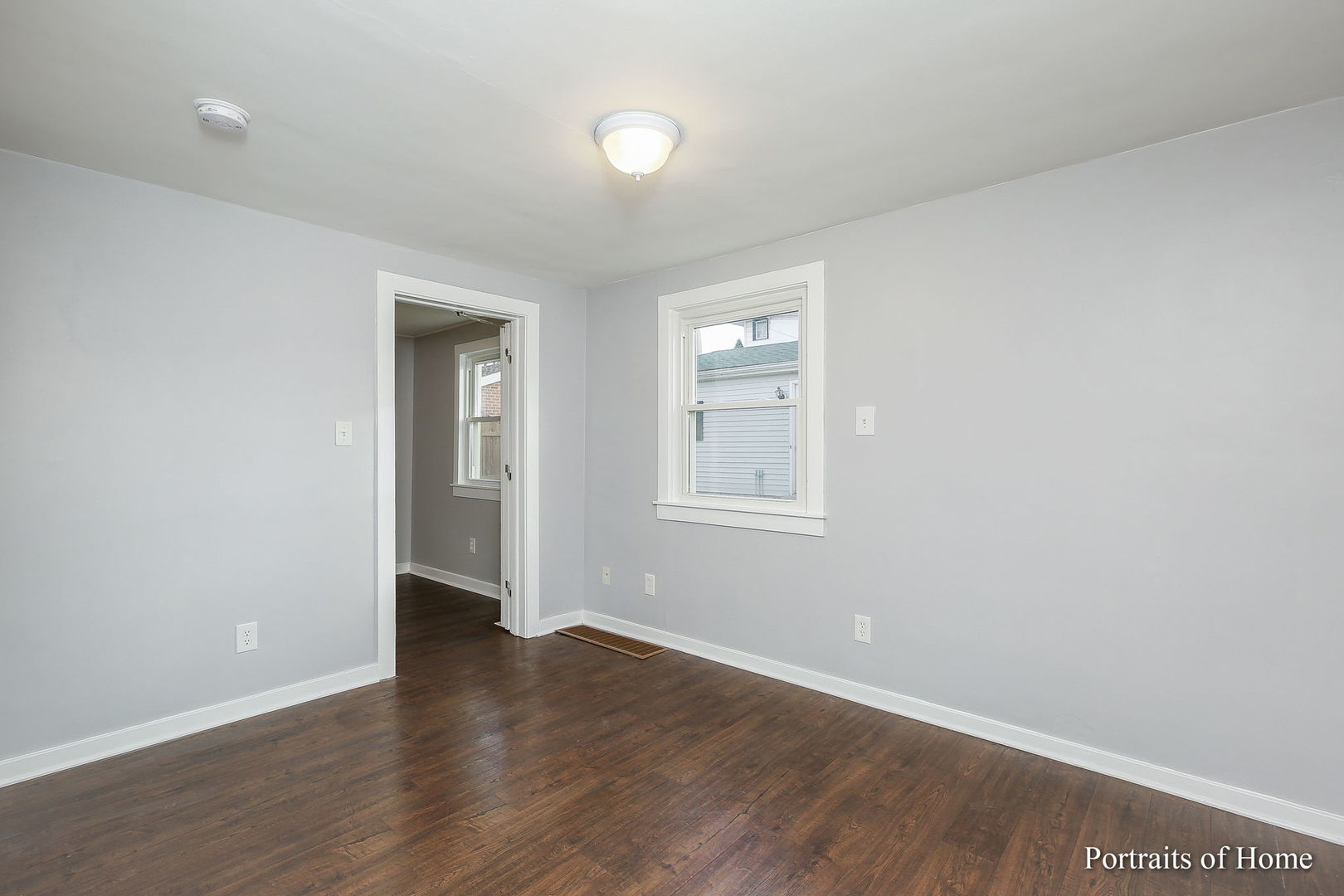952 Black Road Joliet, IL 60435 - Photo 10 of 25 an empty room with wooden floor and windows
