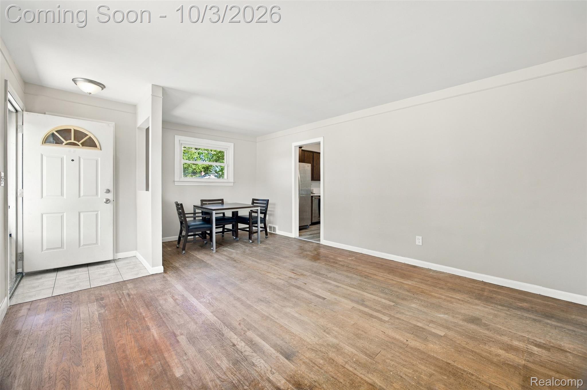 556 Henry Ruff Road Garden City, MI 48135 - Photo 11 of 49 Hardwood flooring, light gray wall finishes, white trim, and a white front entry door with an arched transom