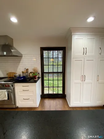 a kitchen with stainless steel appliances granite countertop a stove a sink and a refrigerator