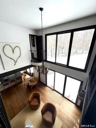 a hallway with furniture and a large window