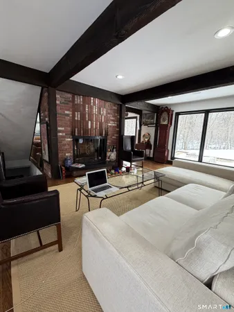 a living room with furniture and large windows