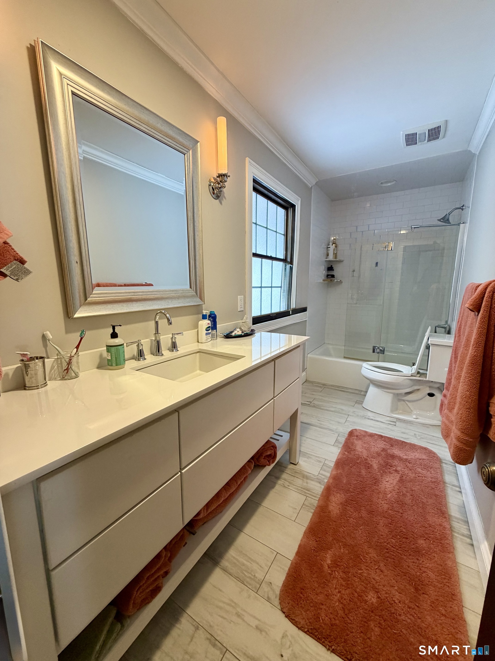 488 Cognewaugh Road Greenwich, CT 06807 - Photo 34 of 40 a spacious bathroom with a double vanity sink and a mirror