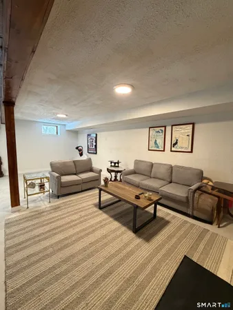 a living room with furniture and a rug