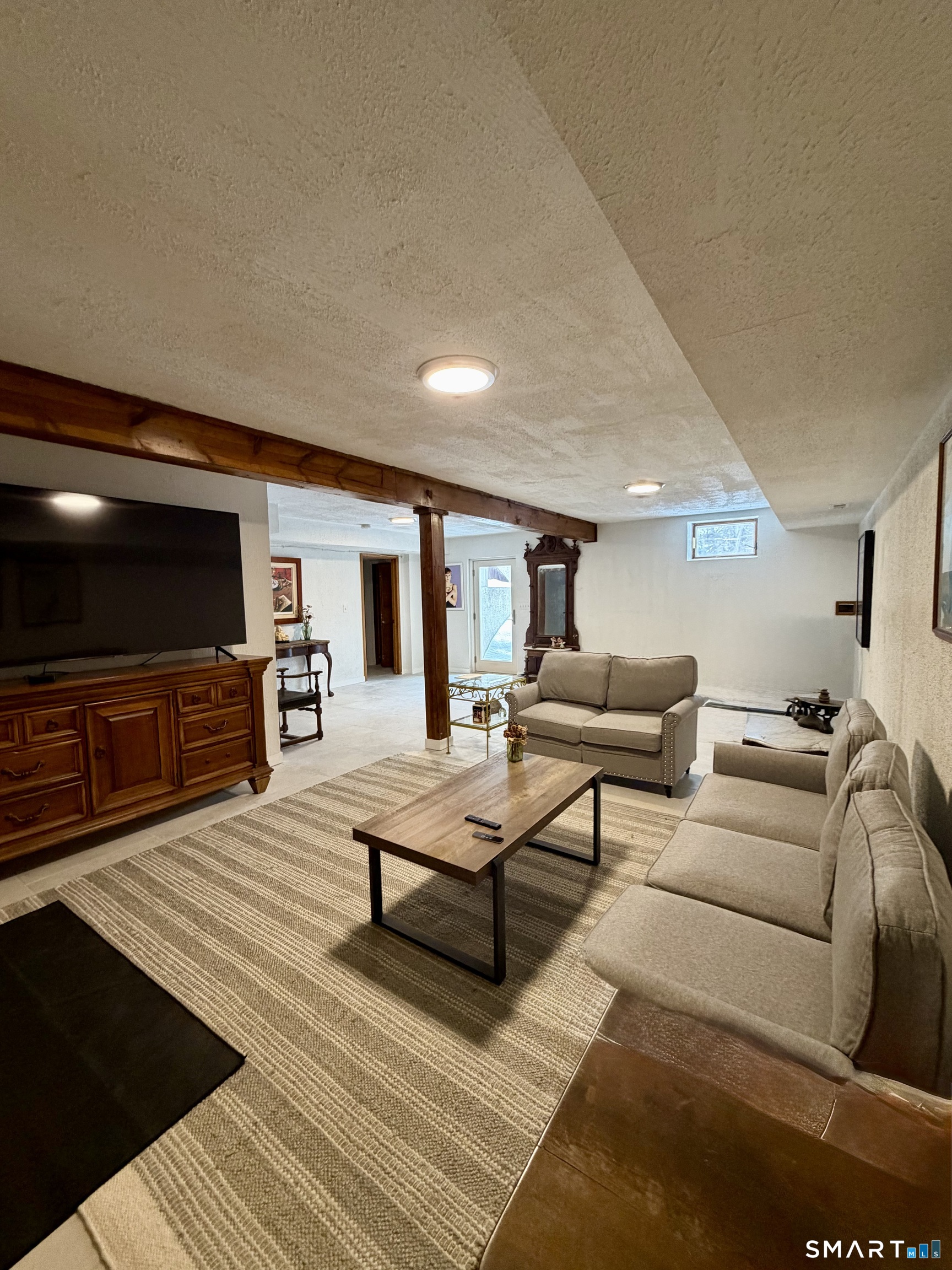 488 Cognewaugh Road Greenwich, CT 06807 - Photo 36 of 40 a living room with furniture and a flat screen tv