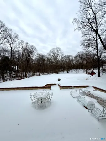 a view of swimming pool with trees and sitting space