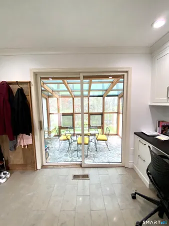 a living room with furniture and a flat screen tv with a large window