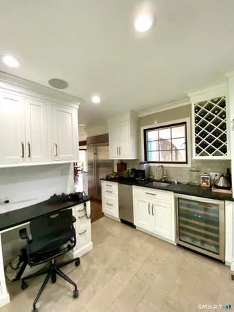a kitchen with granite countertop a sink and cabinets