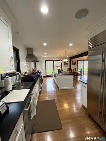 a large kitchen with stainless steel appliances lots of counter space and a refrigerator