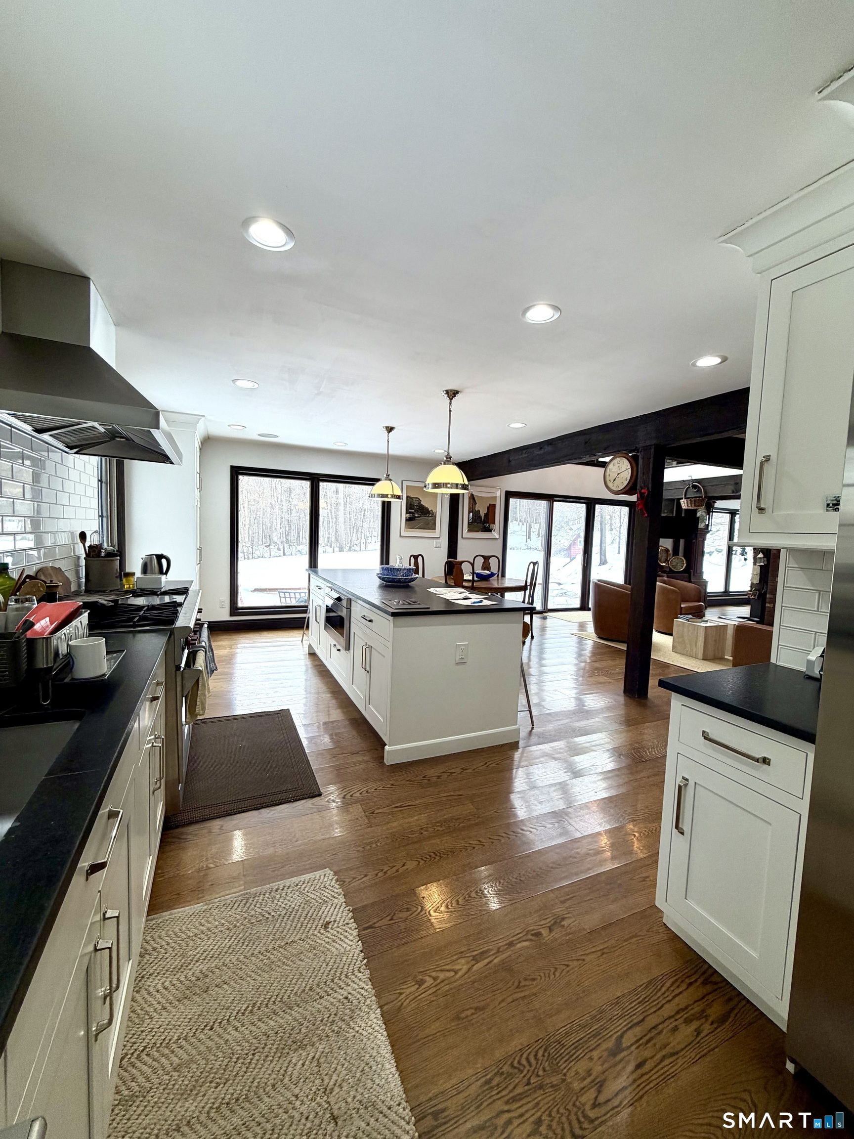 488 Cognewaugh Road Greenwich, CT 06807 - Photo 9 of 40 a view of a living room and kitchen with a large window