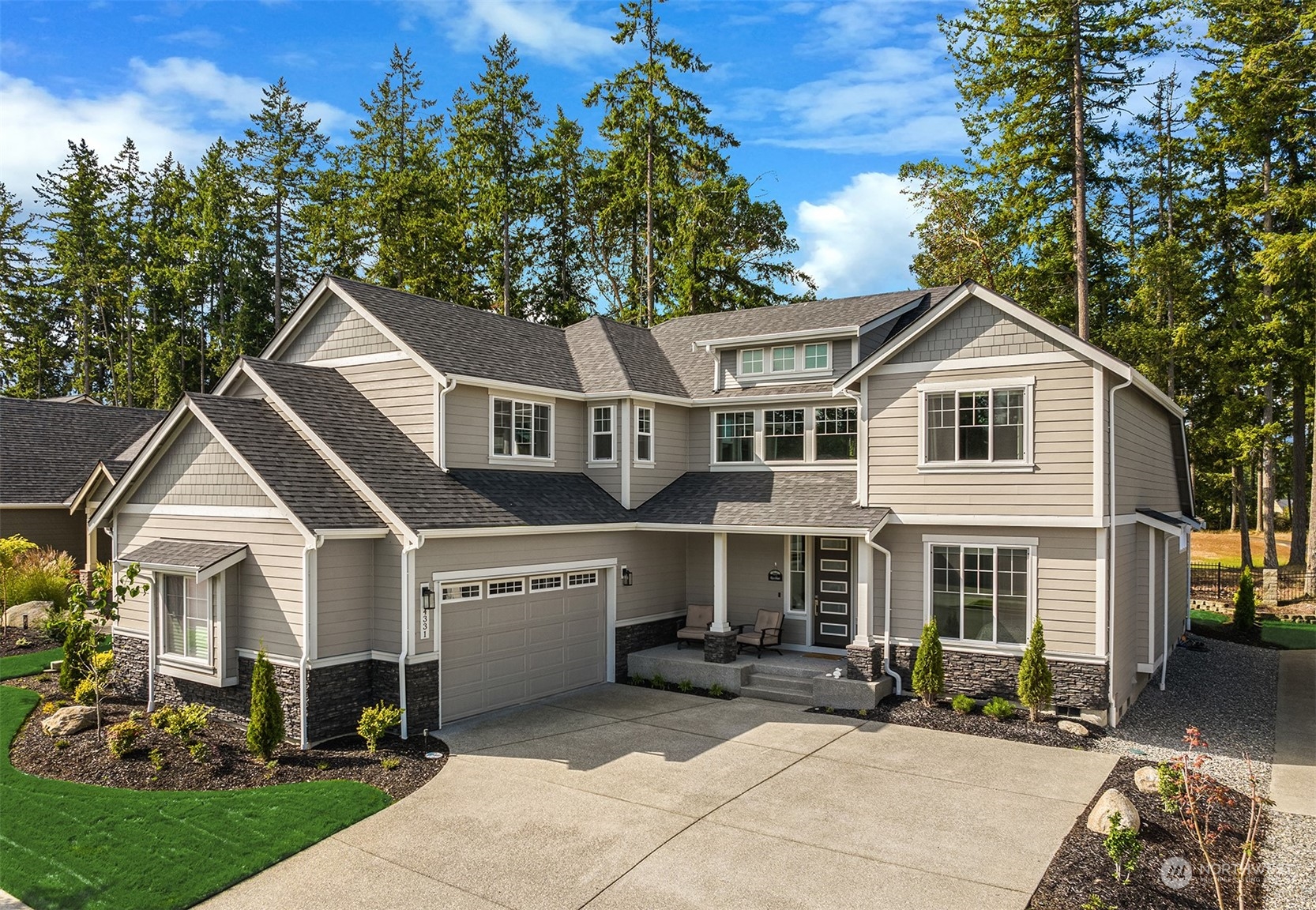 a front view of a house with a yard and outdoor seating