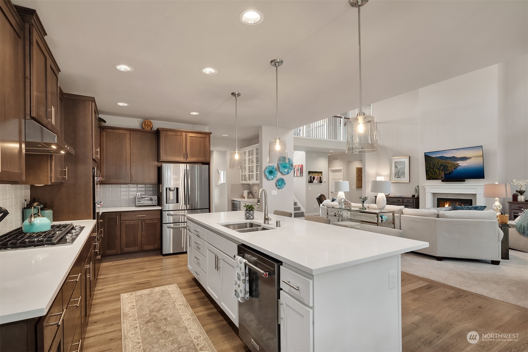 4331 Caddyshack Drive Northeast Lacey, WA 98516 - Photo 12 of 34 a large kitchen with kitchen island a large island a sink a stove and a chandelier